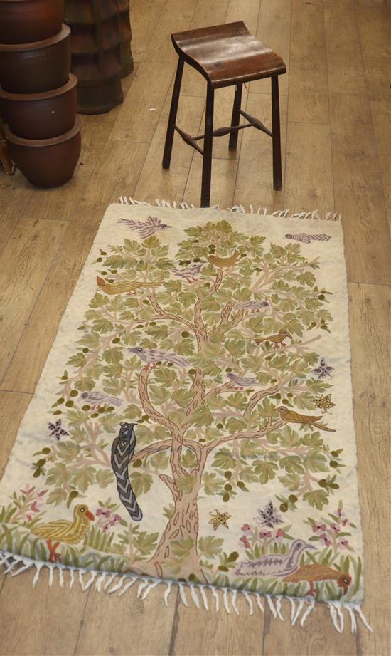 A crewel work rug and a beech music stool